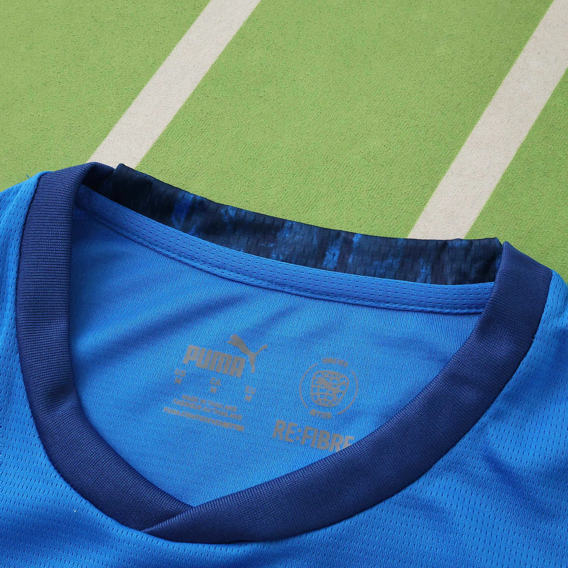 Detalle del cuello redondo en azul marino con patrón gráfico interior de la selección de Islandia.