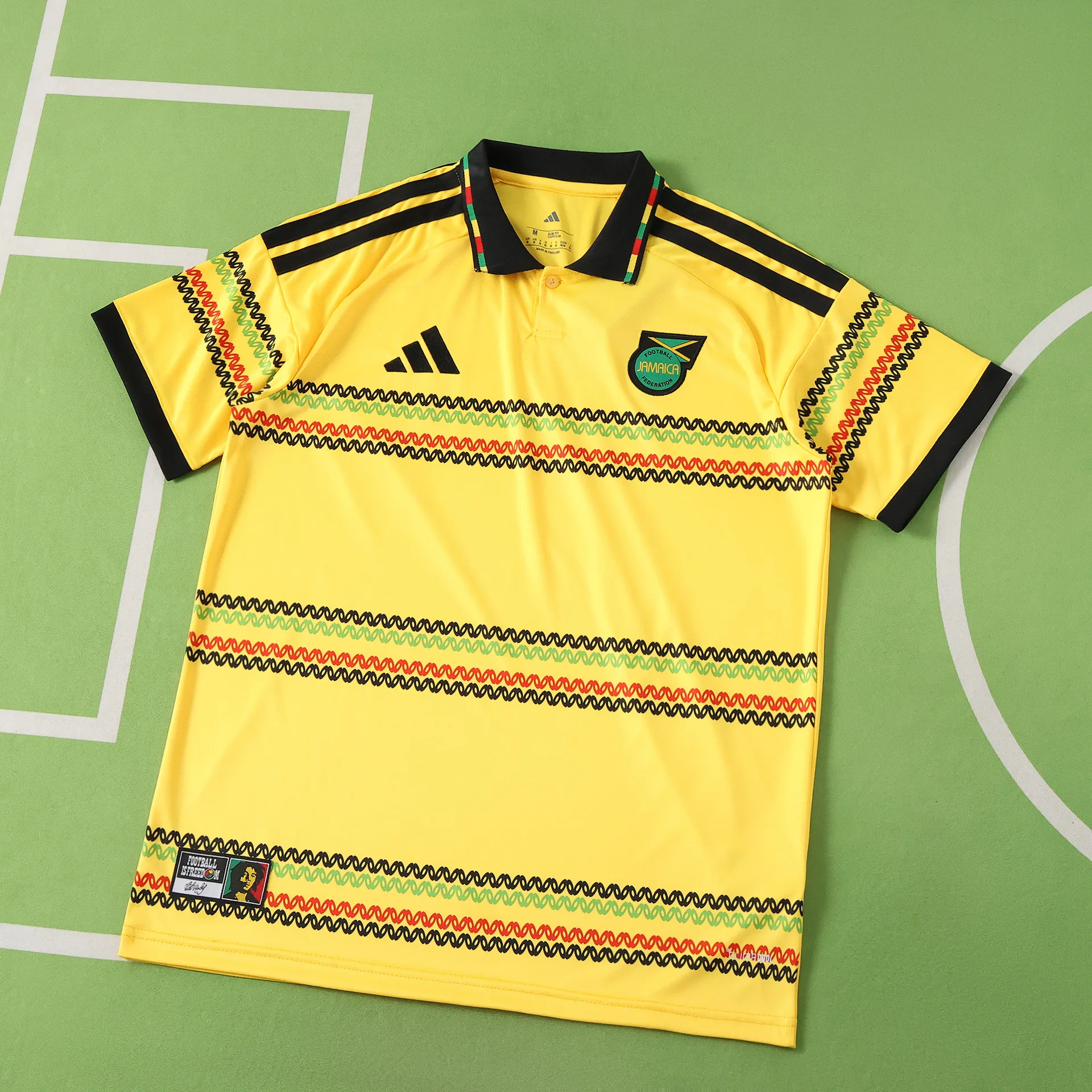 Vista frontal completa de la camiseta de Jamaica para el Mundial 2026, color amarillo con franjas horizontales estampadas.