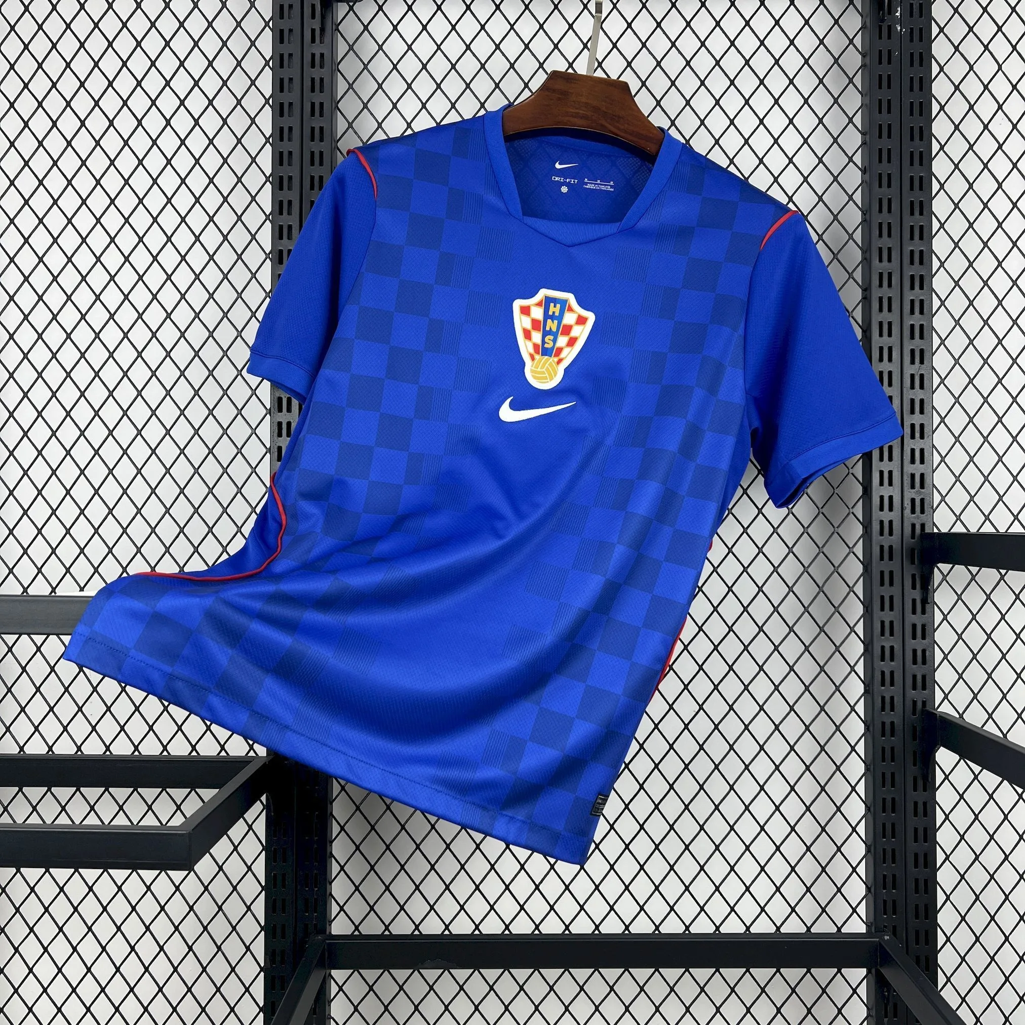 Imagen frontal completa de la camiseta visitante de Croacia para el Mundial 2026 en color azul con diseño de damero moderno.